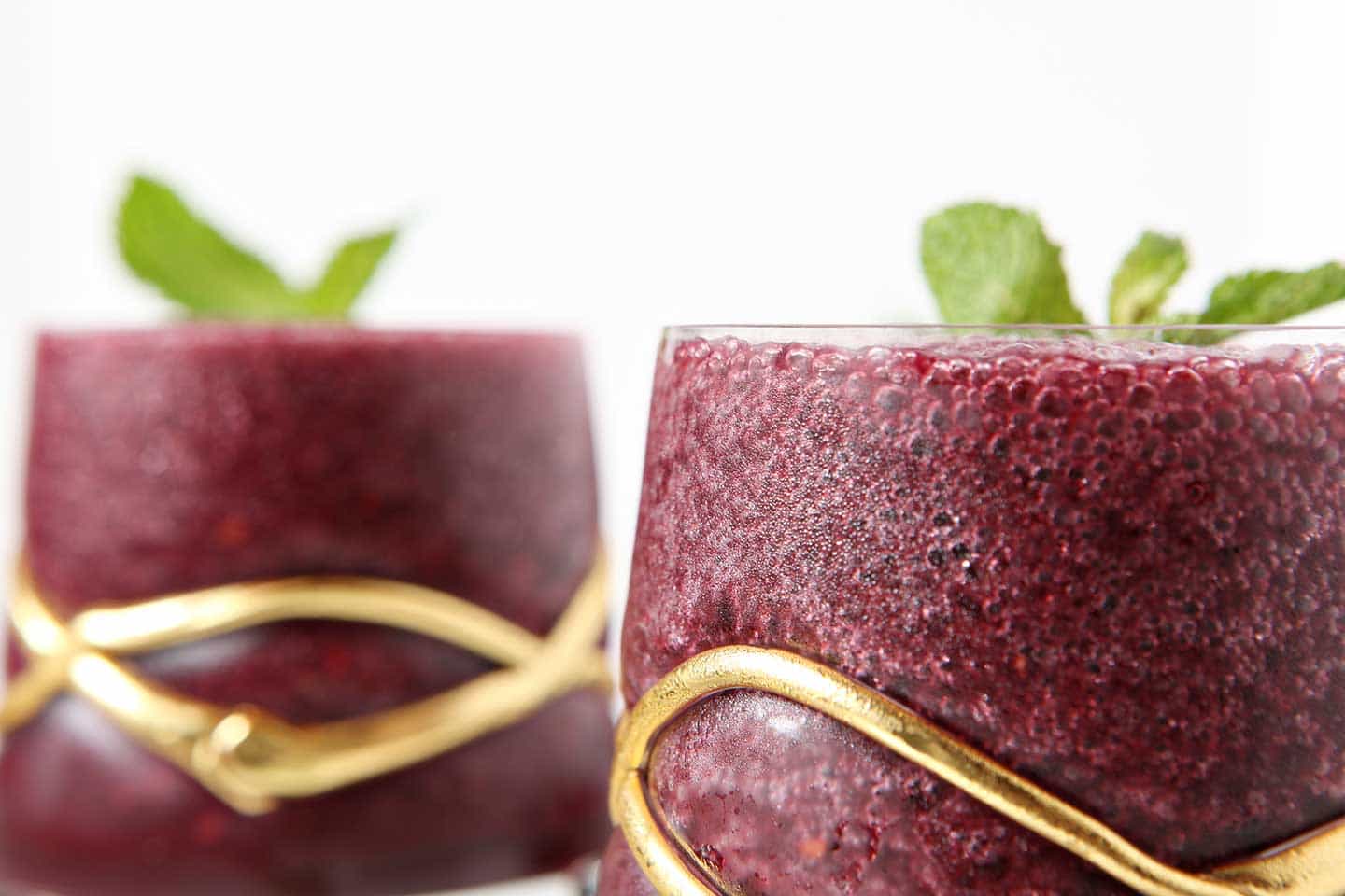 Close up of Blackberry Gin Slush in glass with mint garnish 