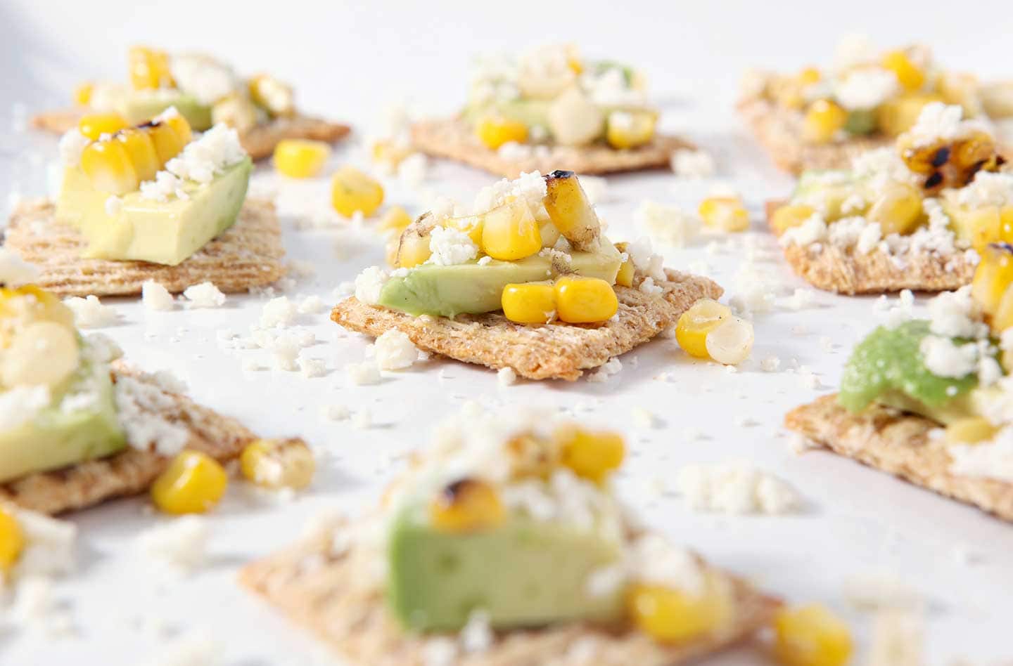 Close up of Cotija Corn Avocado Crackers on white platter 