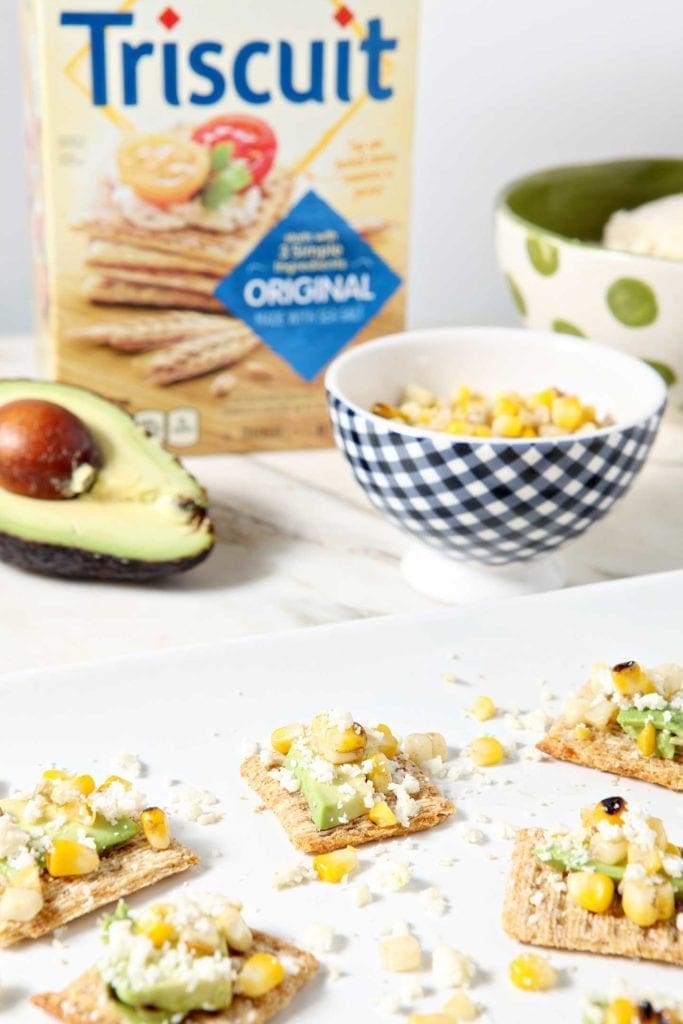 Platter of Cotija Corn Avocado Crackers in front of ingredients 