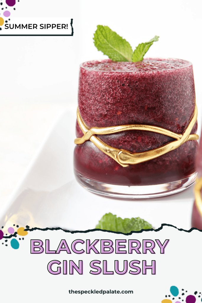 Close up of a slushy purple drink garnished with mint in a decorative glass with the text Blackberry Gin Slush