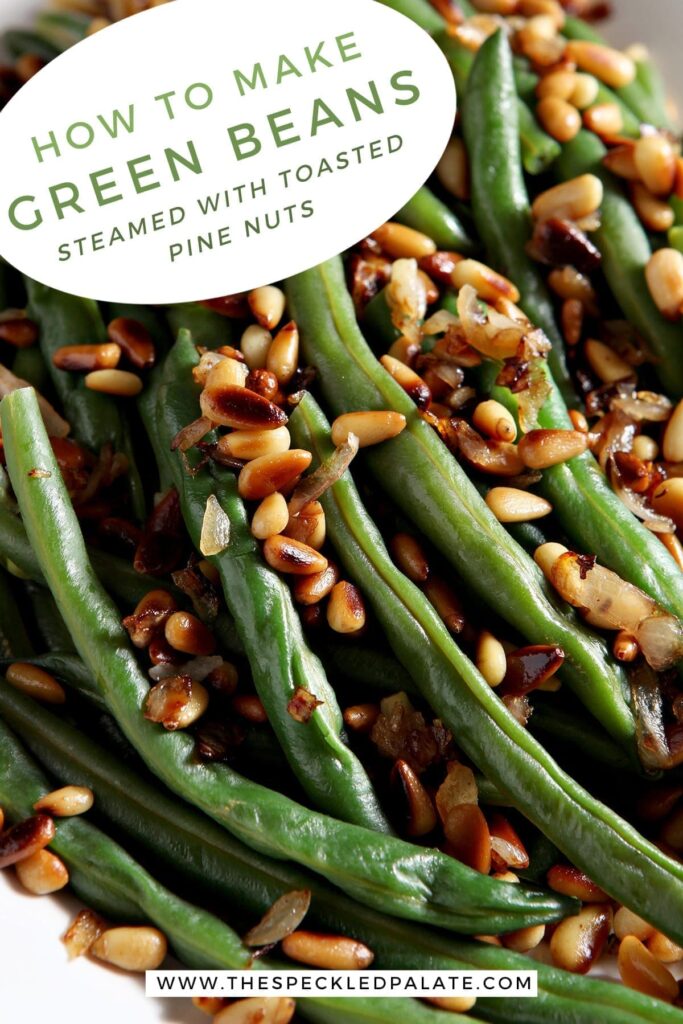 Close up of a platter holding Vegan Green Beans garnished with Toasted Pine Nuts and shallots with the text 'how to make green beans. steamed with toasted pine nuts.'