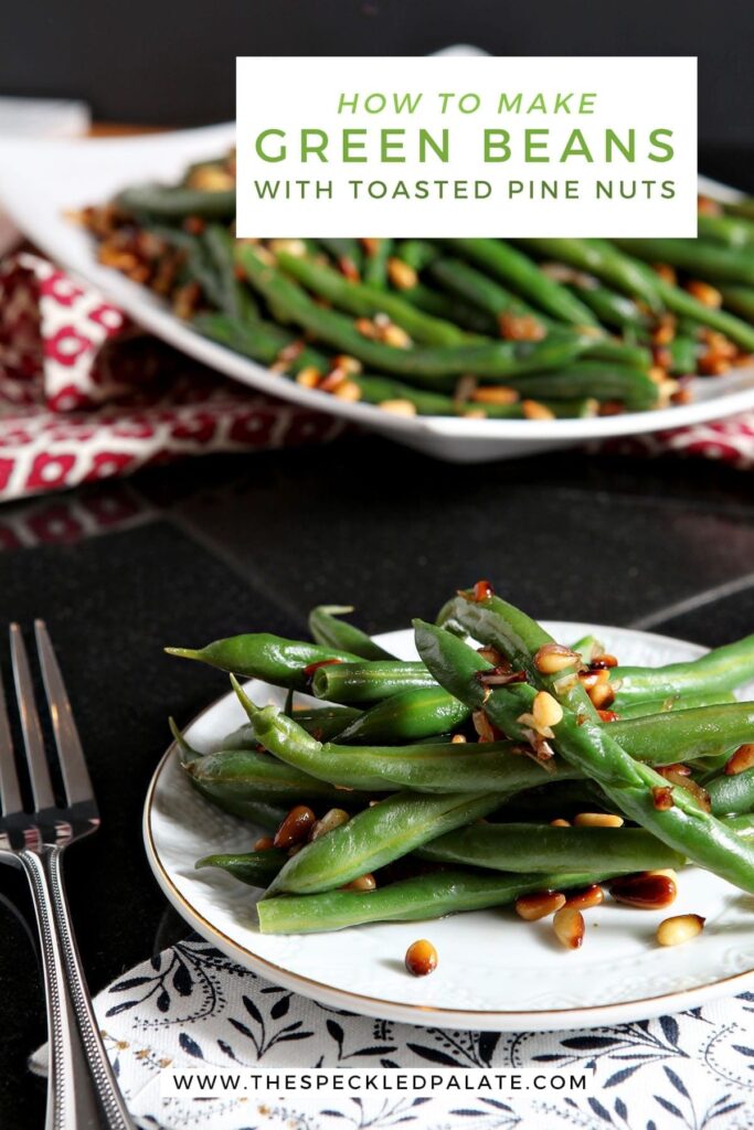 A white plate holds a serving of Vegan Green Beans with Toasted Pine Nuts and shallots with the text 'how to make green beans with toasted pine nuts'