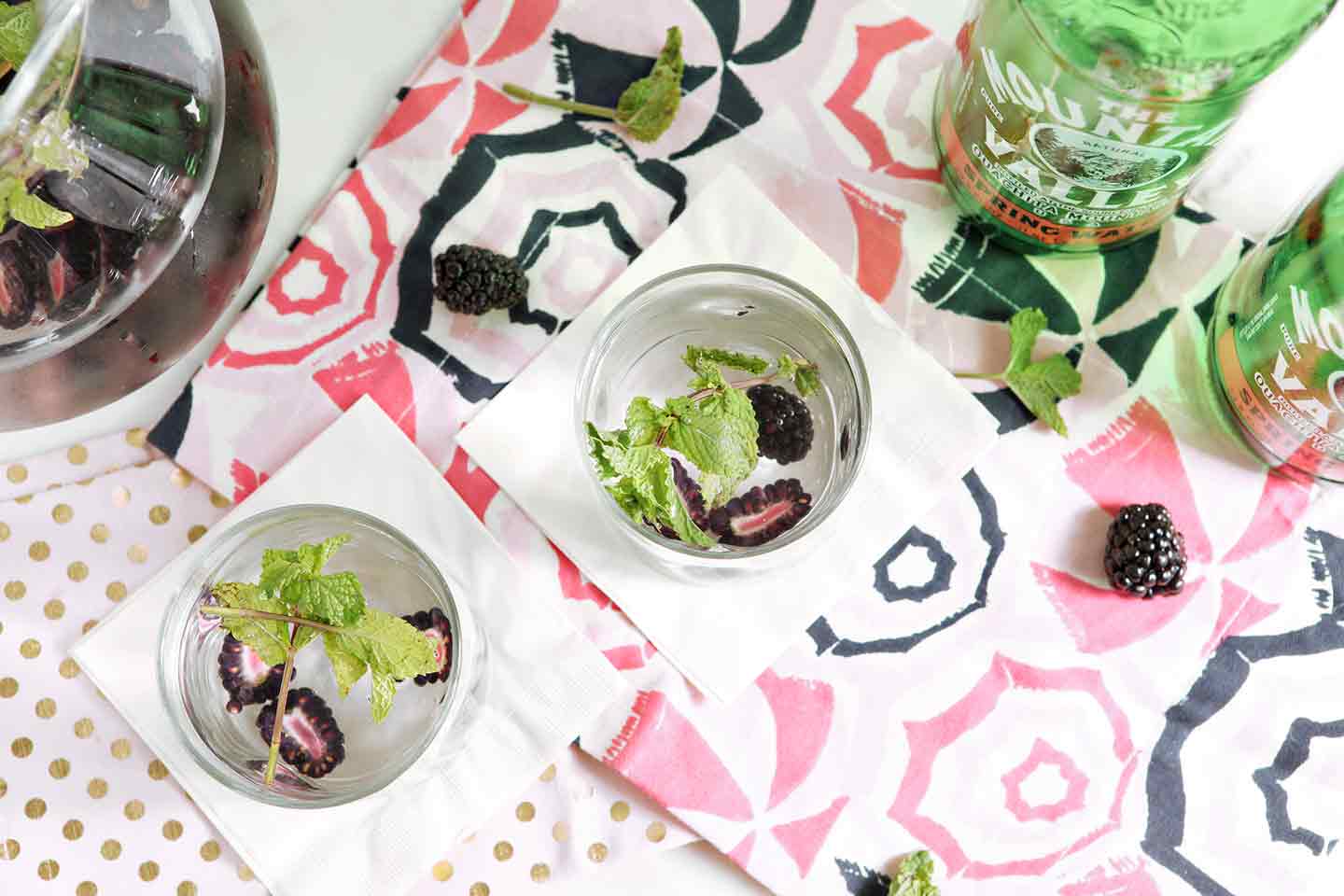 Overhead view of blackberry mint spa water on napkins 