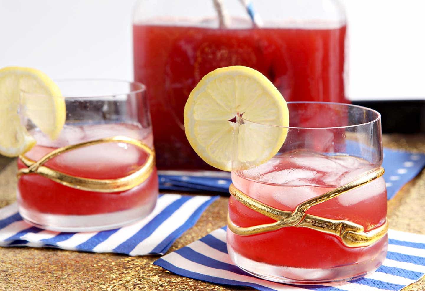 Two glasses of Cherry Lemon Tea in front of pitcher 