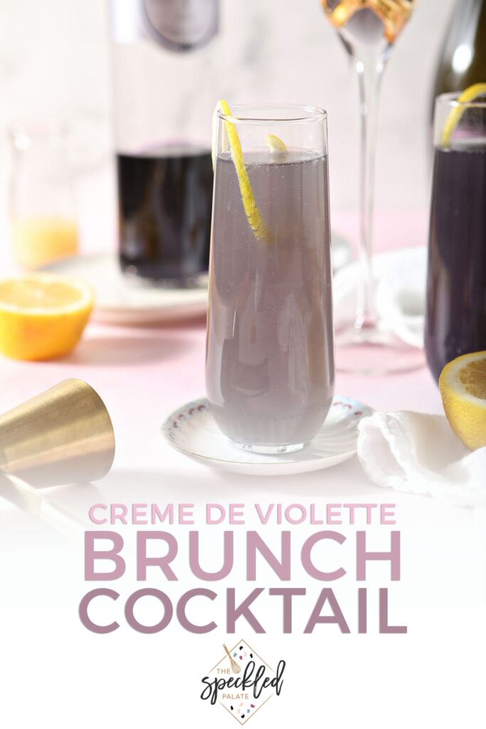 A purple champagne cocktail sits on a plate with the text 'creme de violette brunch cocktail'