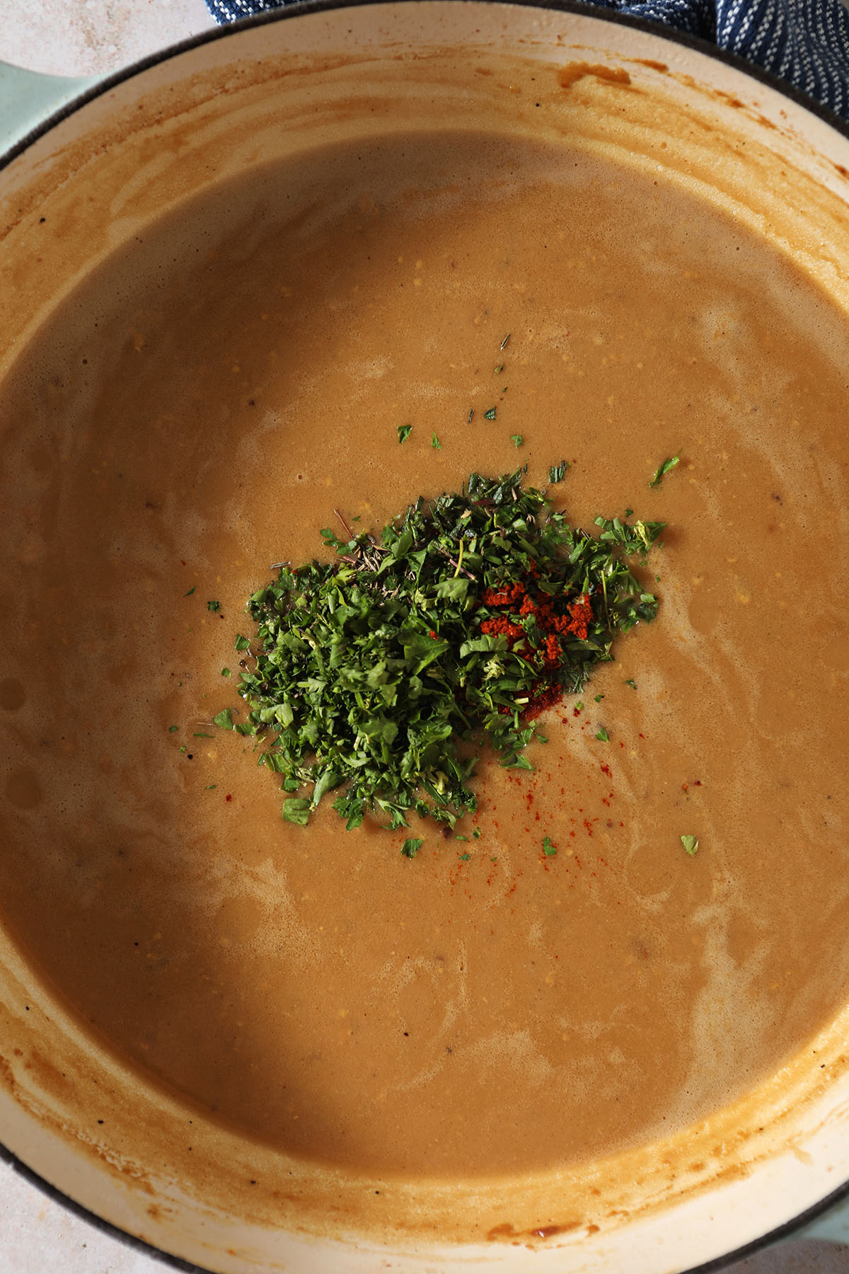 Seasonings on top of a mustard sauce in a skillet