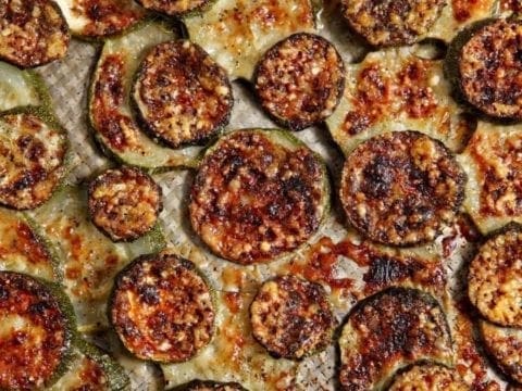 Overhead close up view of baked and broiled parmigiano reggiano zucchini