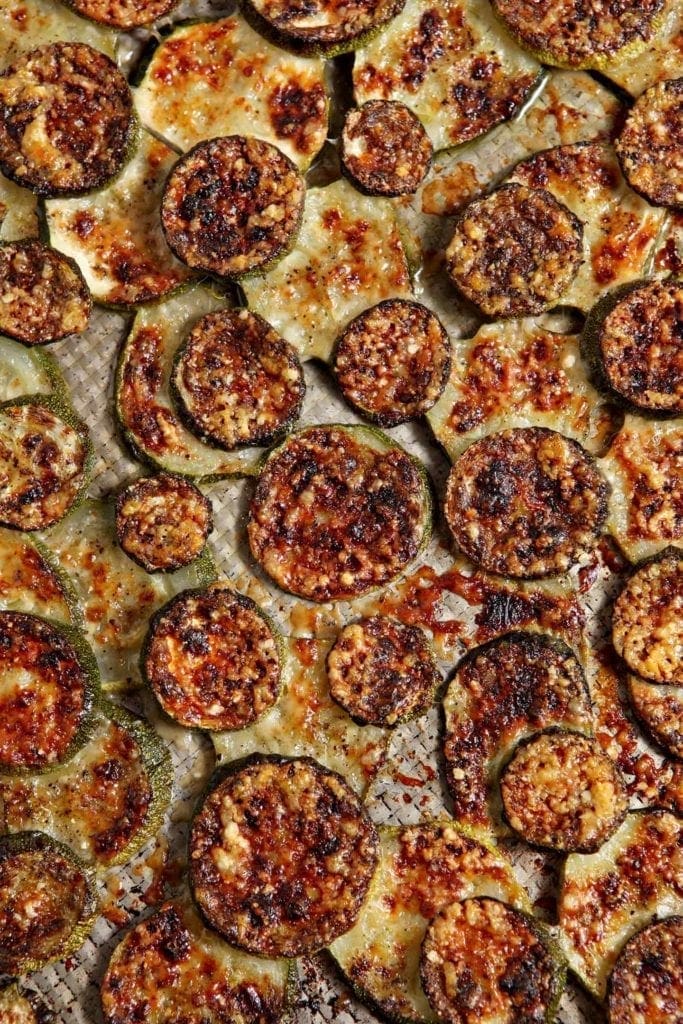 Overhead close up view of baked and broiled parmigiano reggiano zucchini 