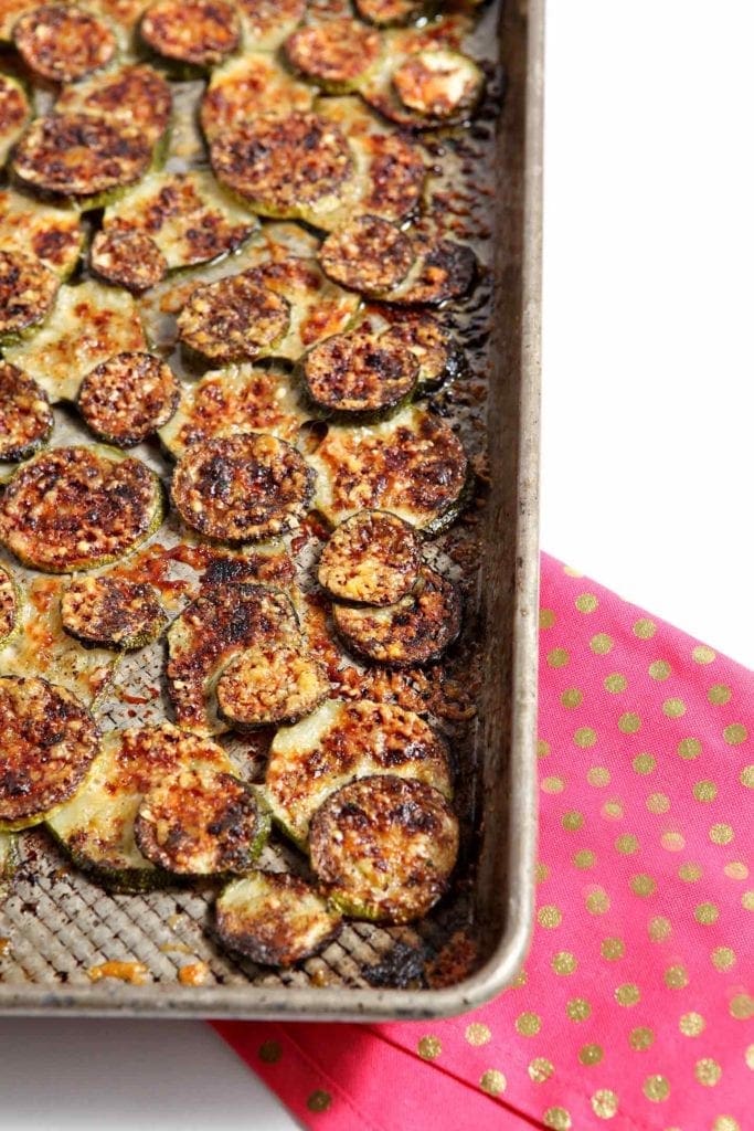 Baked and broiled parmigiano reggiano zucchini in baking sheet 