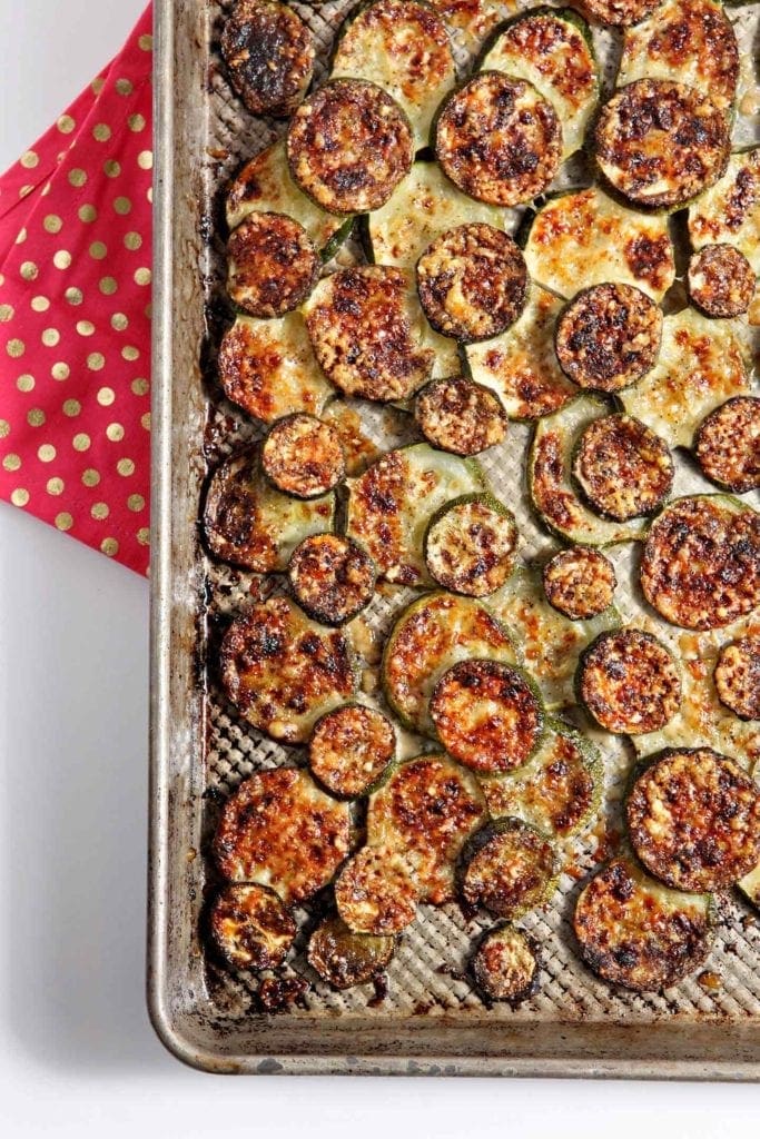 Overhead view of parmigiano reggiano zucchini in baking sheet 