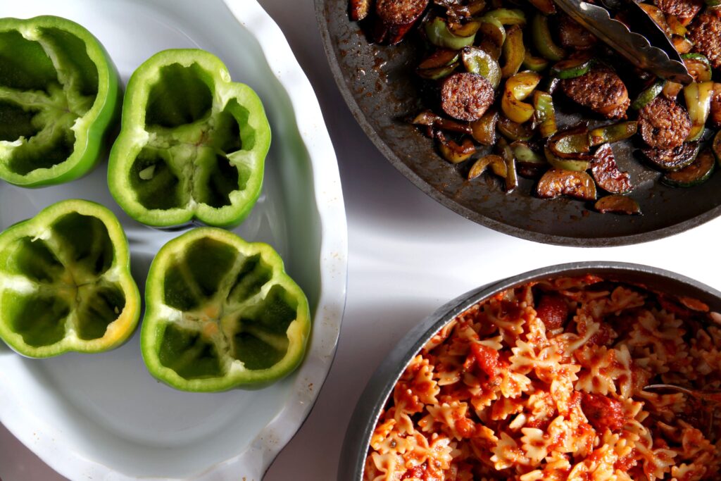 Ingredients to make stuffed bell peppers in bowls and casserole dishes before putting together