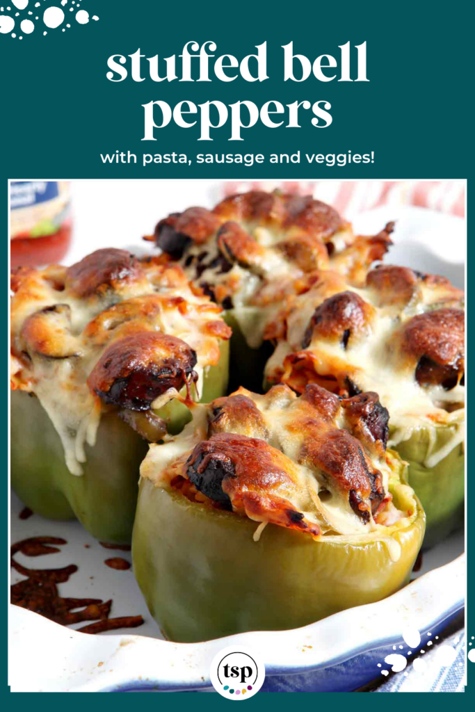 Close up of baked peppers topped with cheese in a pan with the text Stuffed Bell Peppers with pasta, sausage and veggies