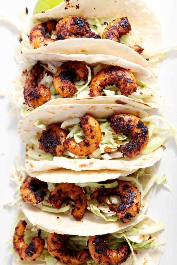 Close up of Blackened Shrimp Tacos from above on a white platter