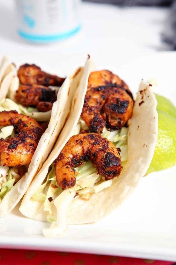 Close up of two blackened shrimp on tortillas