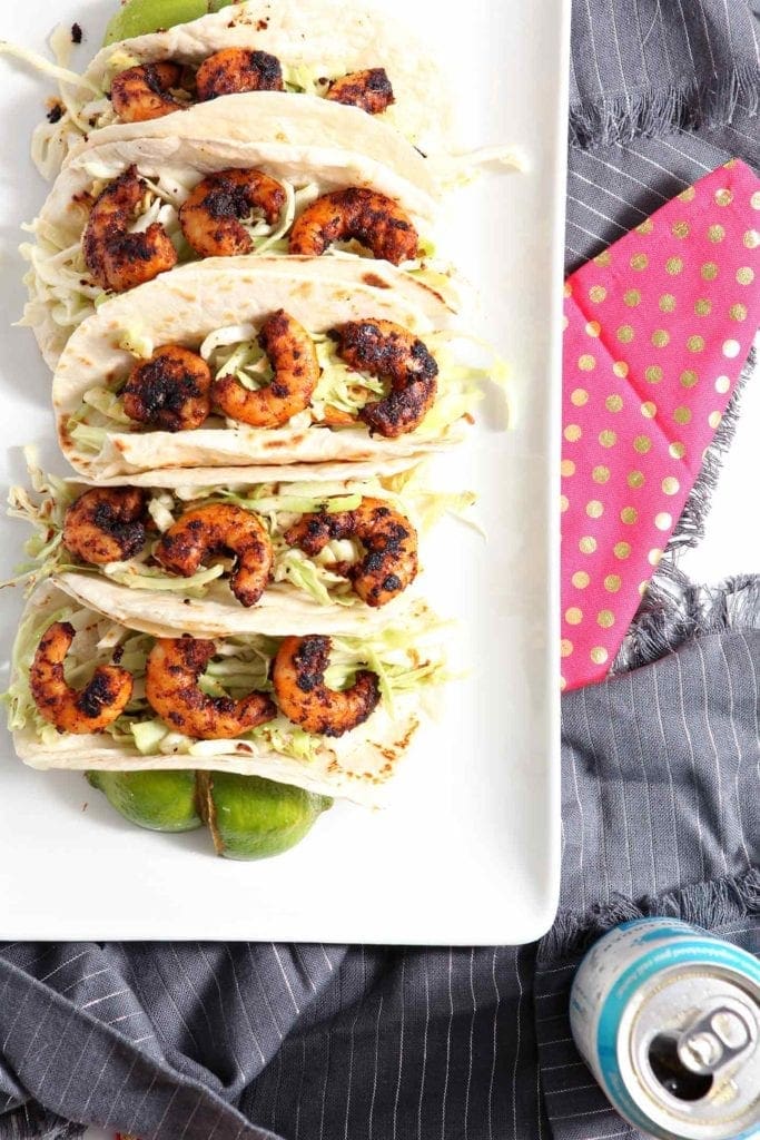 blackened shrimp tacos on a white serving tray