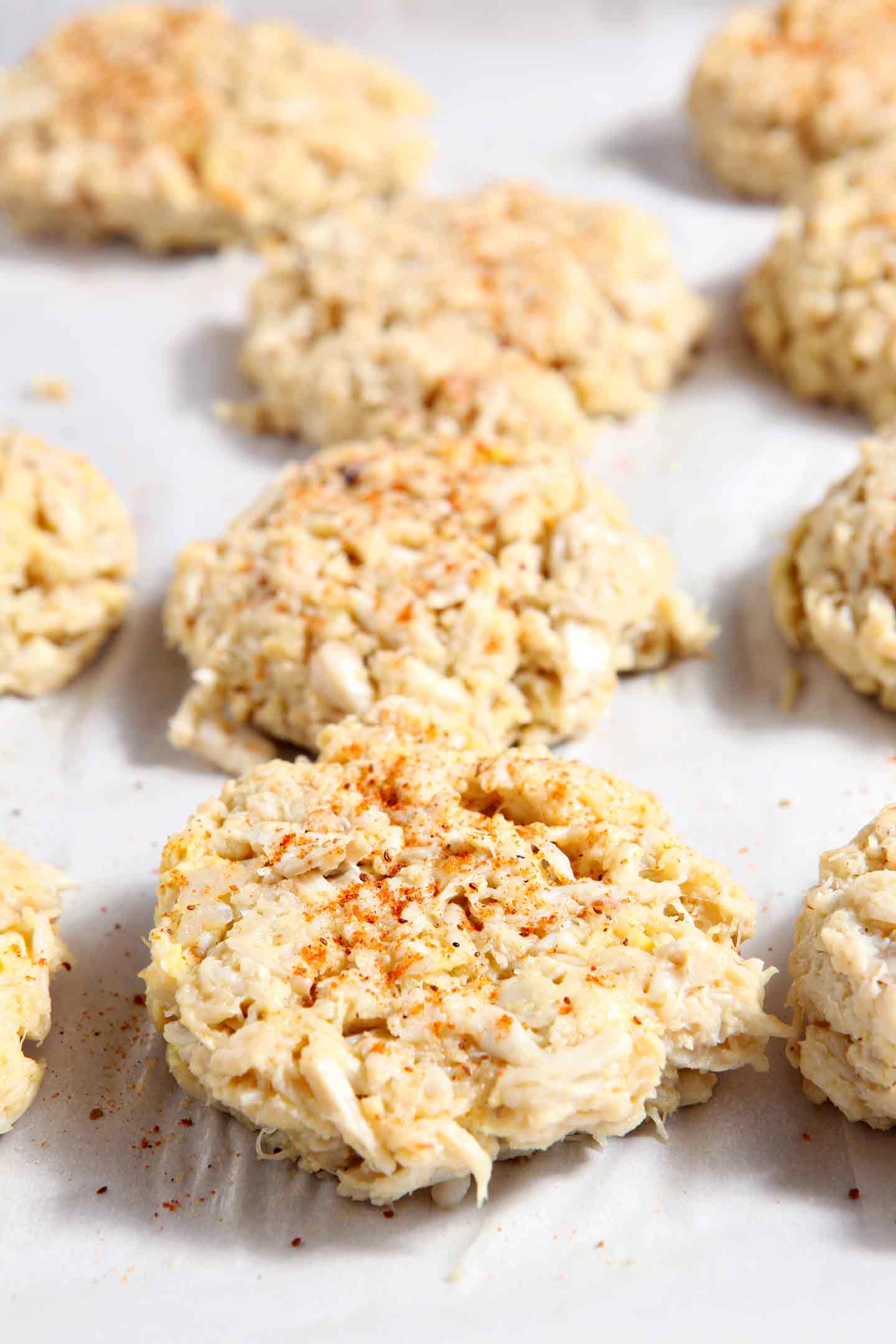 Lumps of crab cakes on baking sheet 