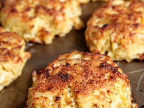 Close up of broiled crab cakes on baking sheet