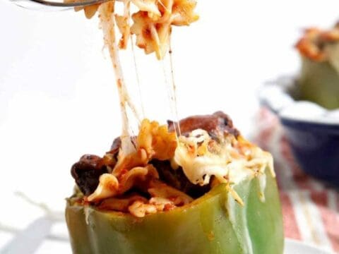 Fork pulling cheese and stuffing out of stuffed pepper