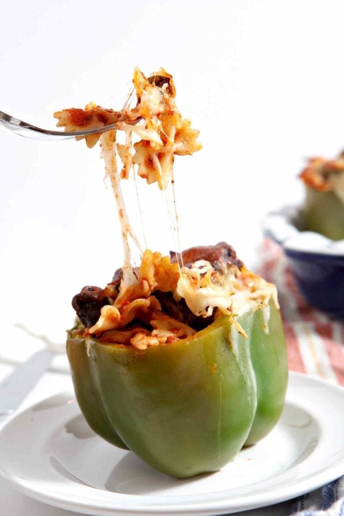 Fork pulling cheese and stuffing out of stuffed pepper