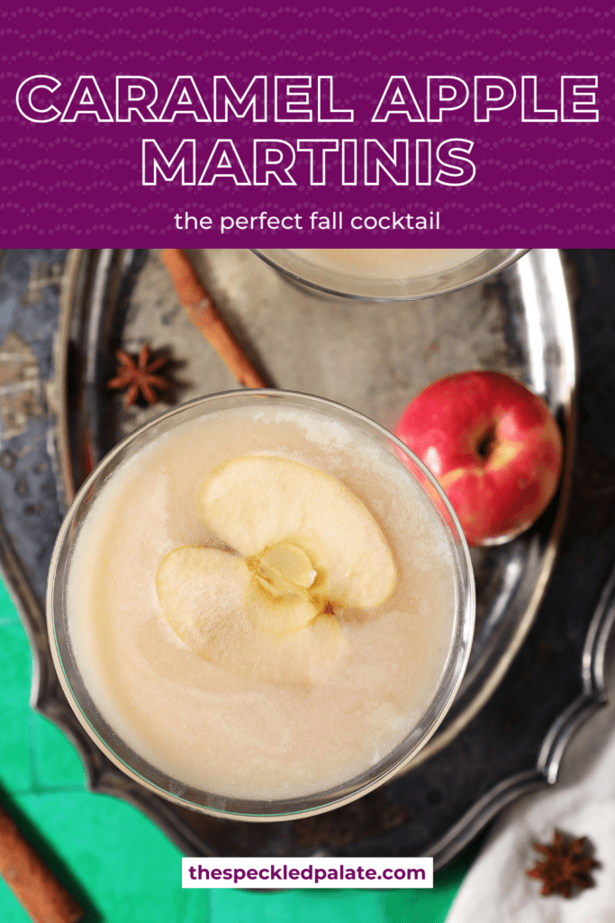 Overhead of two salted caramel appletinis garnished with apple slices on a silver tray with spices and an apple with the text caramel apple martinis the perfectcocktail