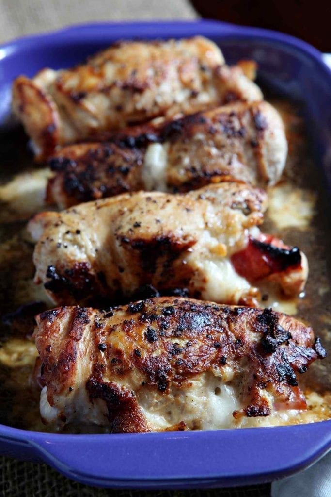 A close up of Chicken Cordon bleu in blue serving dish 