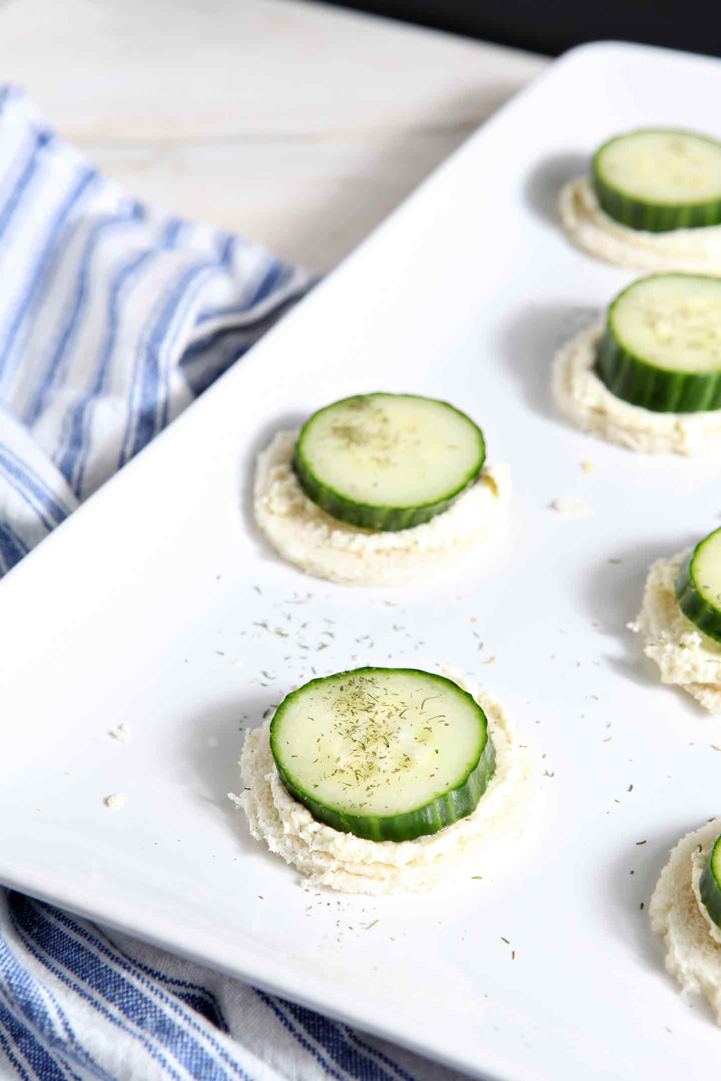 Cucumber slices on top of whipped spread on serving dish 