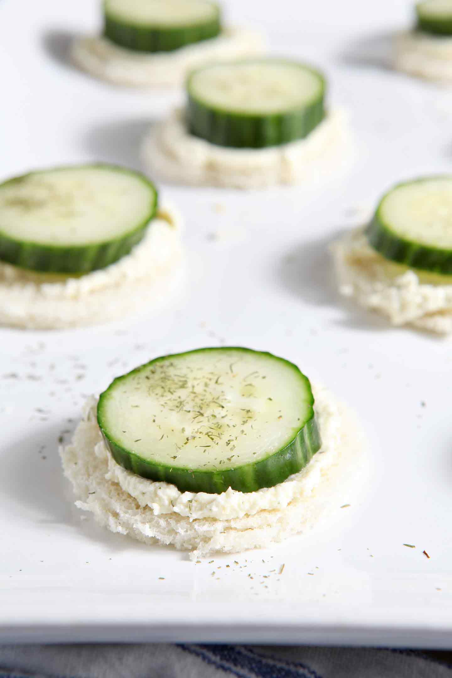 Close up of cucumber slices on whipped spread on serving dish 