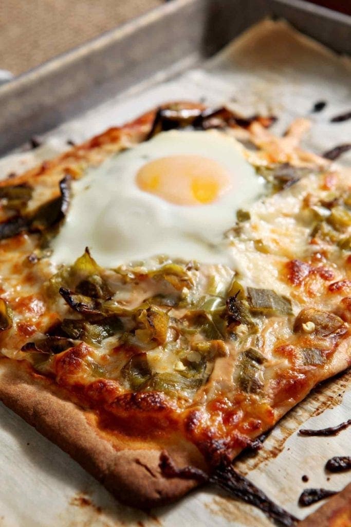 Close up of Hatch Chili Breakfast Flatbread on baking sheet  