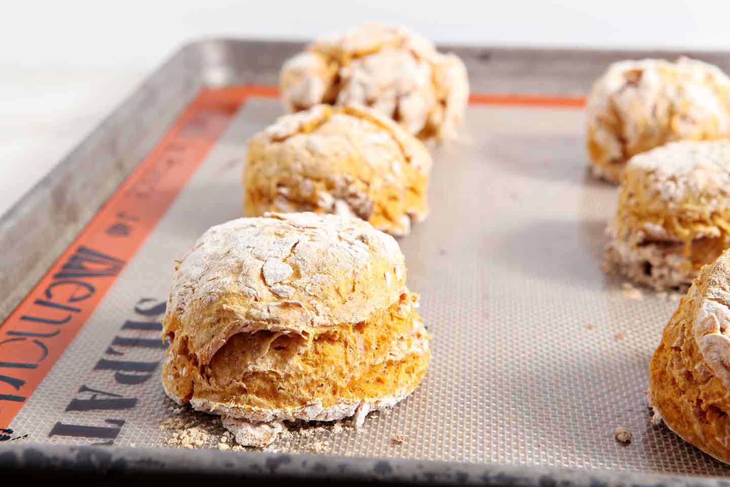 Close up of pumpkin biscuits on baking sheet 