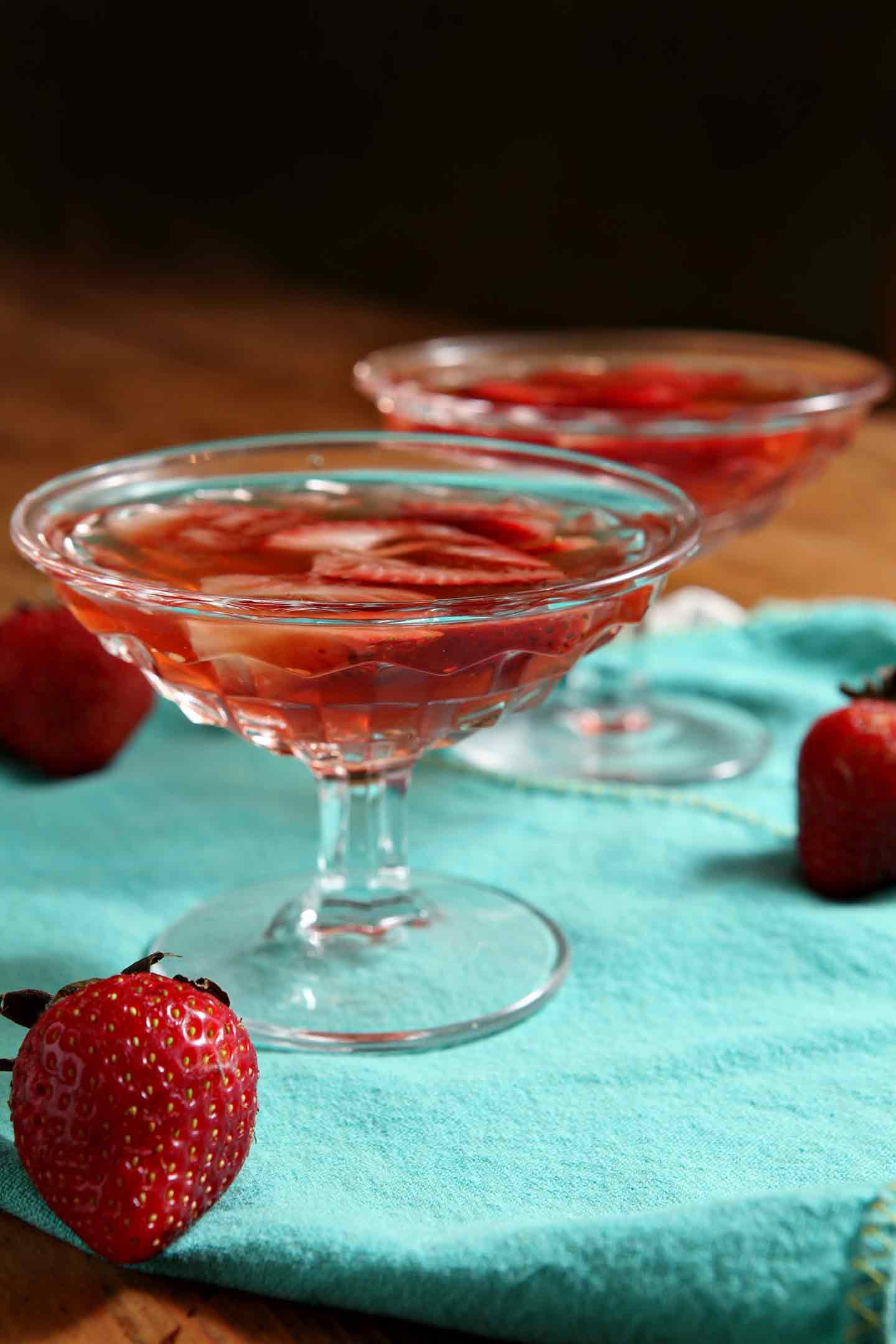 Close up of glass of old fashioned with strawberries 