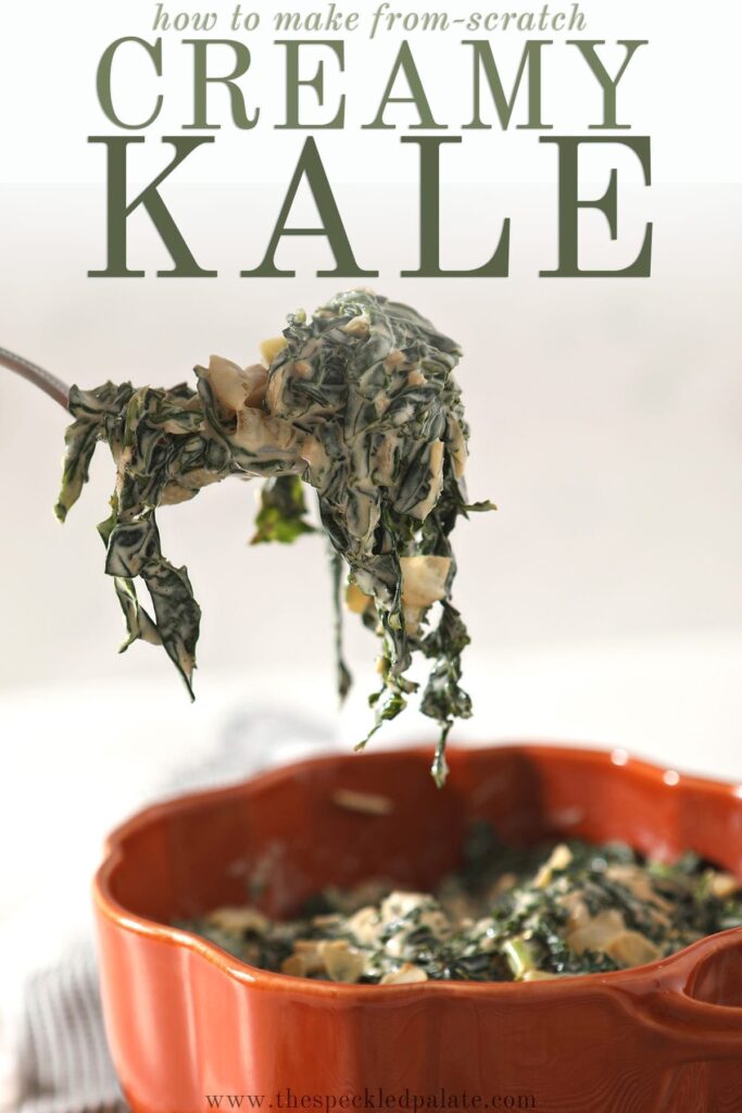 A spoon lifts a spoonful of Creamy Kale out of an orange serving dish that sits on a gray striped towel with the text 'how to make from-scratch creamy kale'