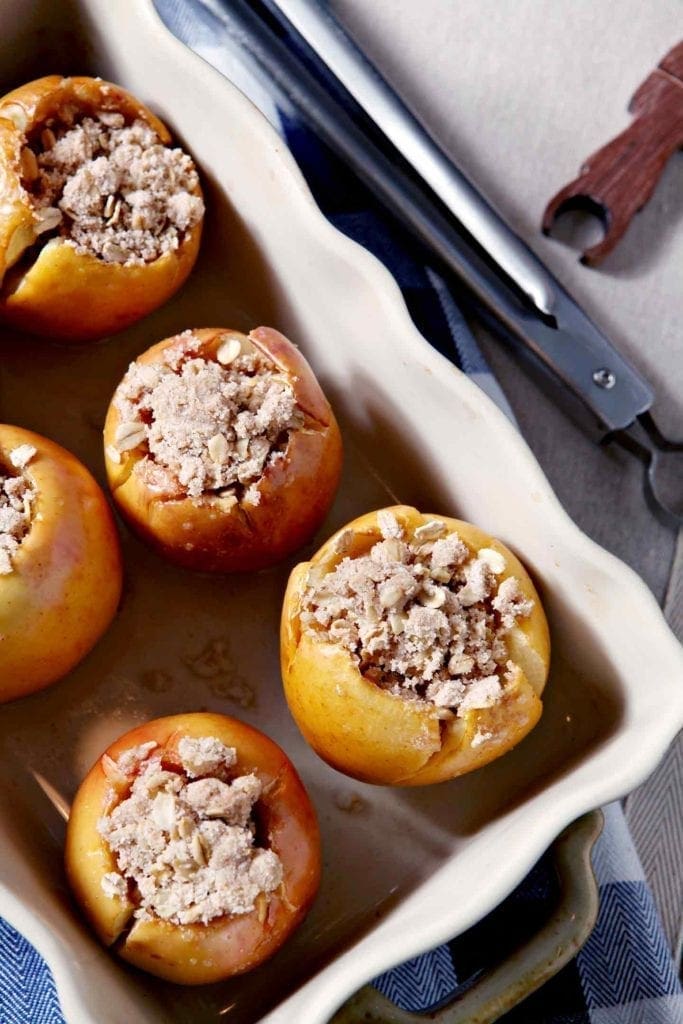 bacon streusel stuffed apples in a white baking dish