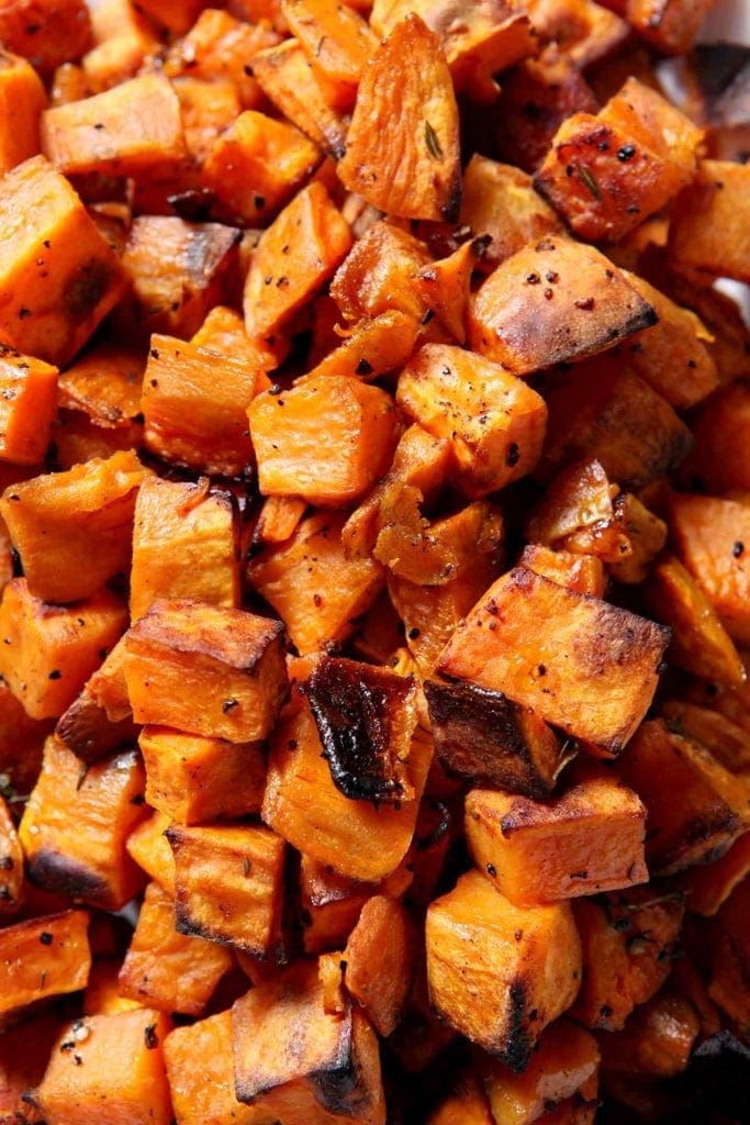 Overhead close up of crispy Bourbon Butter Sweet Potatoes, straight from the oven