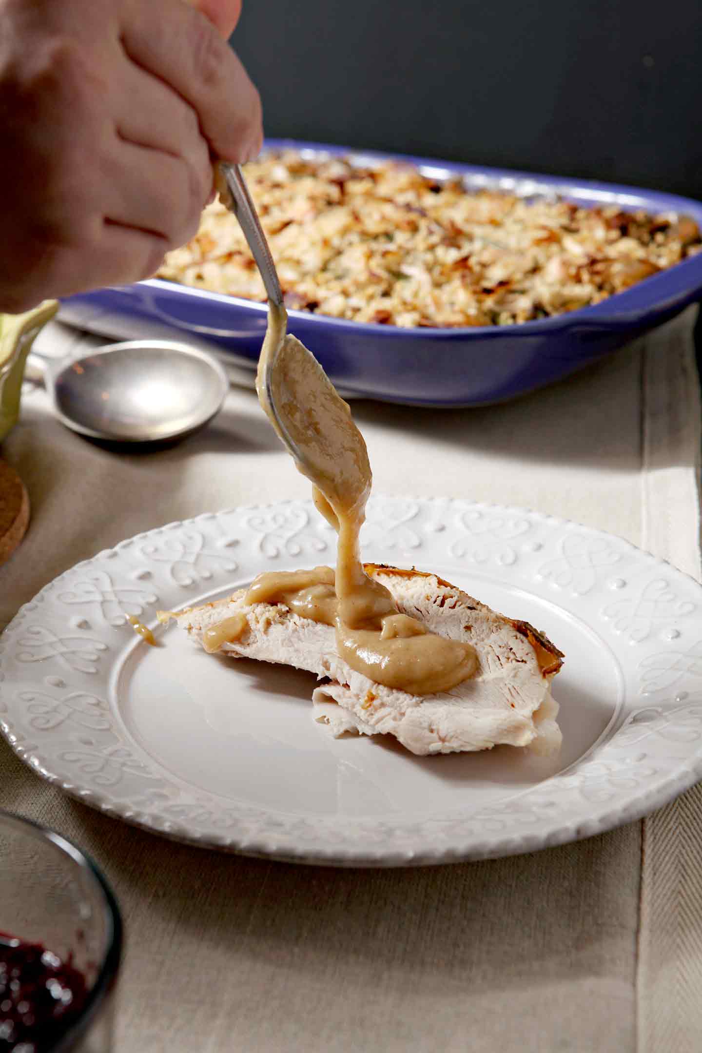 Gravy drizzles of a slice of turkey breast on a plate