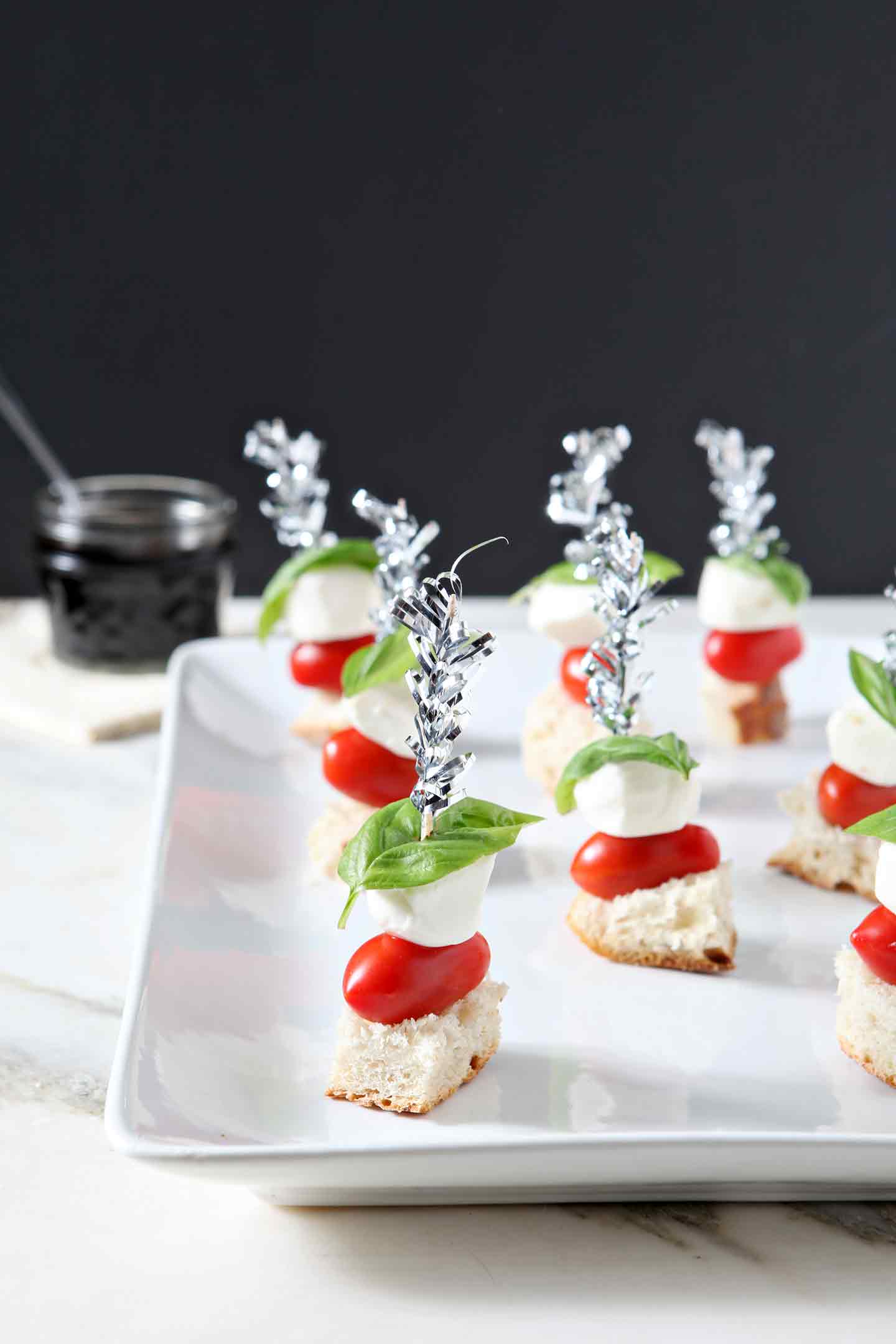 caprese skewers on a white plate