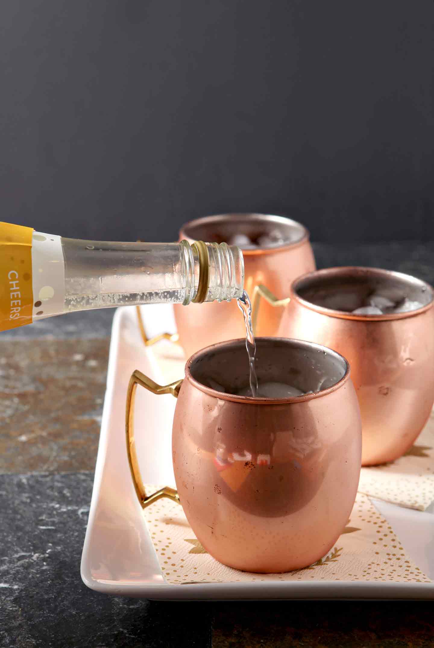 pouring liquid into a copper mug