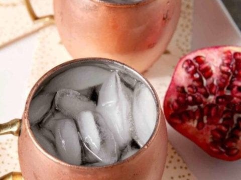 ginger pomegranate mules with a fresh pomegranate