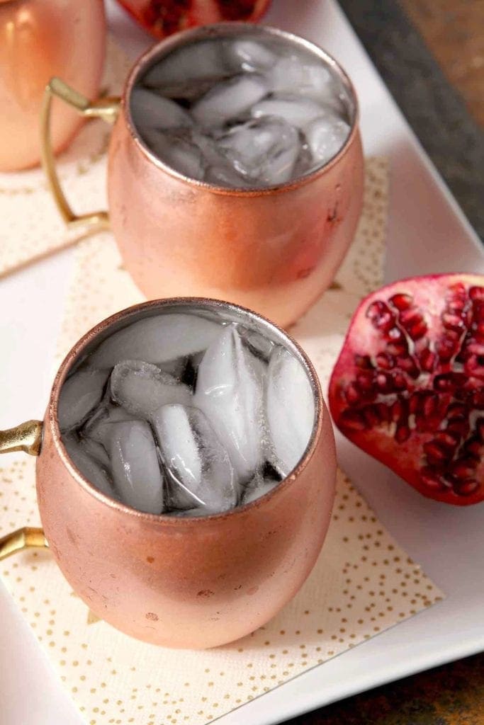 ginger pomegranate mules with a fresh pomegranate