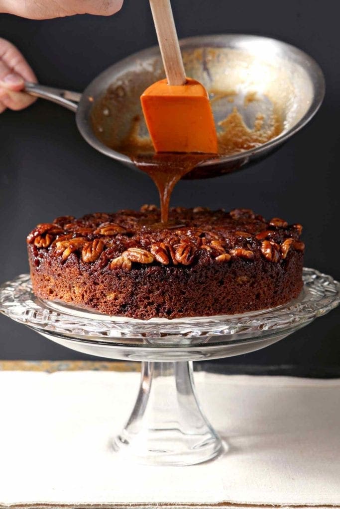 Bourbon Caramel Glaze pours over a cake dotted with pecan halves