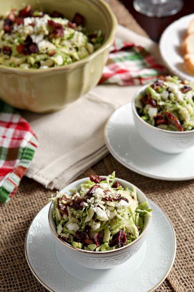 bacon feta brussels sprouts salad in two white bowls