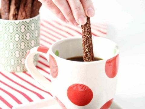 dipping gingerbread biscotti in coffee