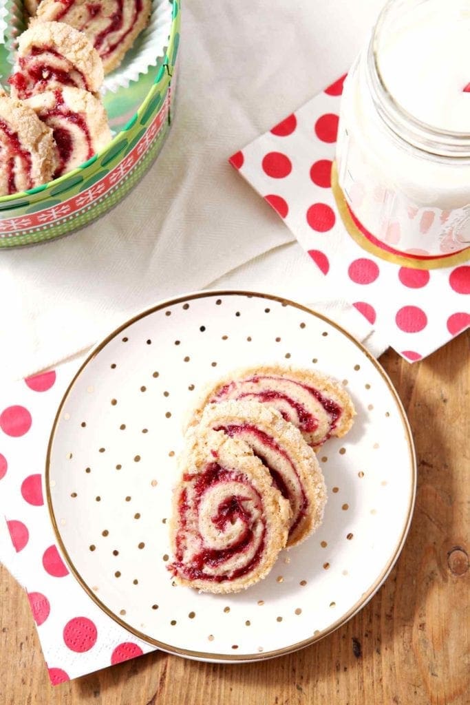 cranberry pinwheel cookies on a white and gold plate