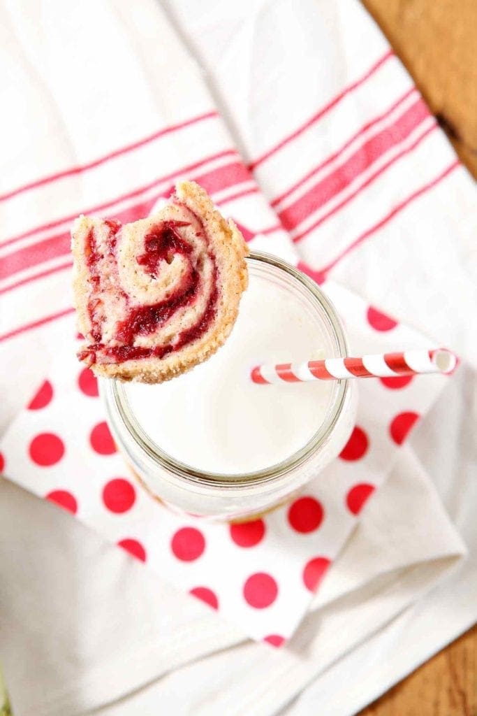 cranberry pinwheel cookie on a glass of milk