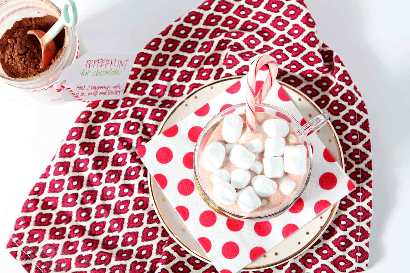 Overhead shot of hot chocolate in mug with marshmallows and candy cane