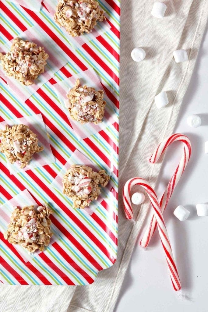 No Bake Peppermint Bark Cookies are shown from above on a colorful platter with marshmallows and candy canes