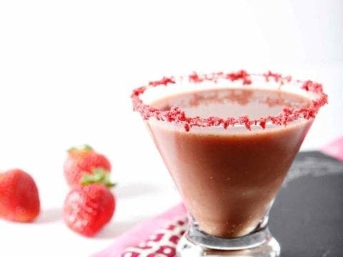 skinny chocolate covered strawberry martini in a glass with fresh strawberries