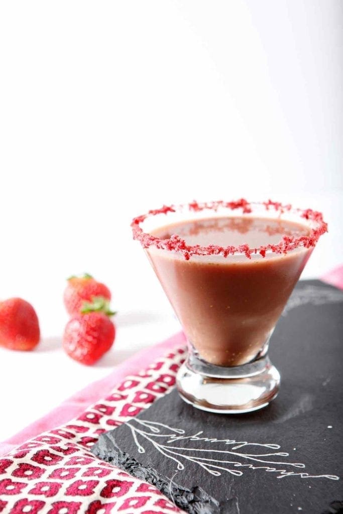 skinny chocolate covered strawberry martini in a glass with fresh strawberries