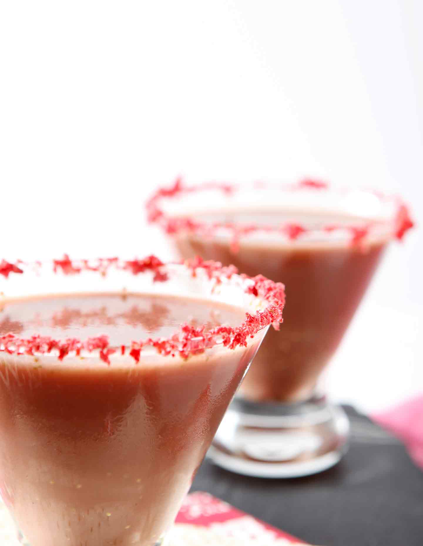 Angled picture of 2 glasses of chocolate covered strawberry martinis