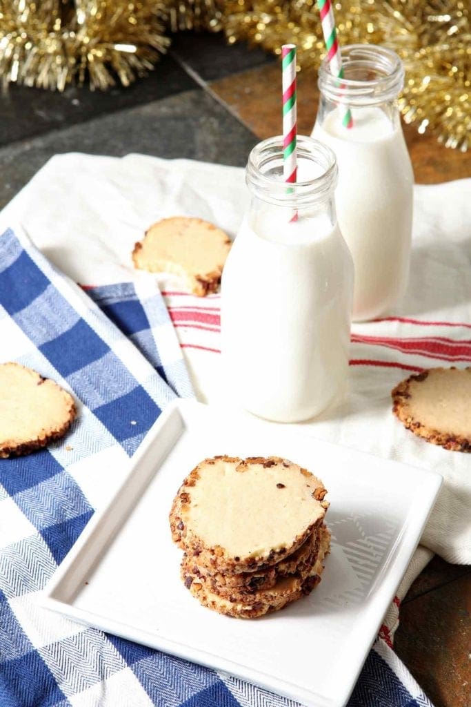 toasted pecan shortbread cookies stacked on a white napkin