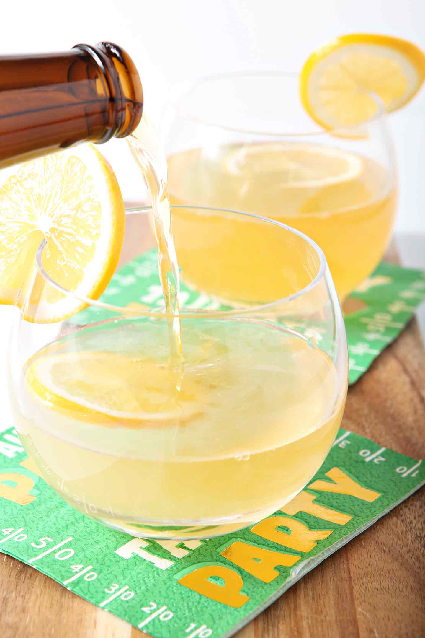 meyer lemon shandy in glasses with lemon wedges